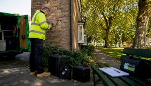 Surveyor inspecting cavity wall insulation at UK home