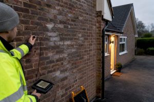 Surveyor examining aged cavity wall insulation
