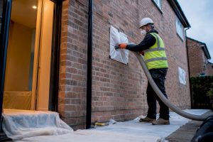 Technician carrying out cavity wall extraction